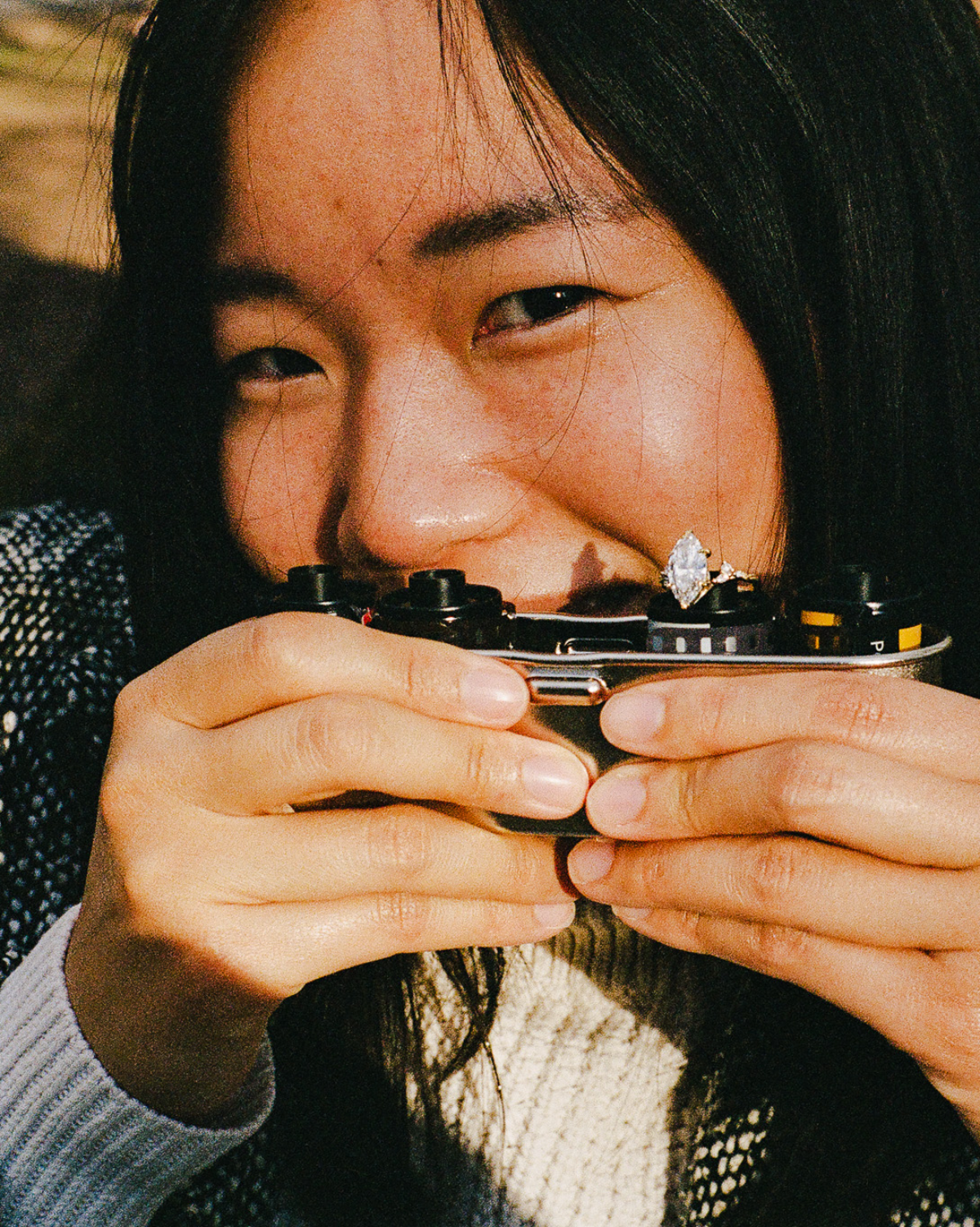 Janet with film camera and engagement ring